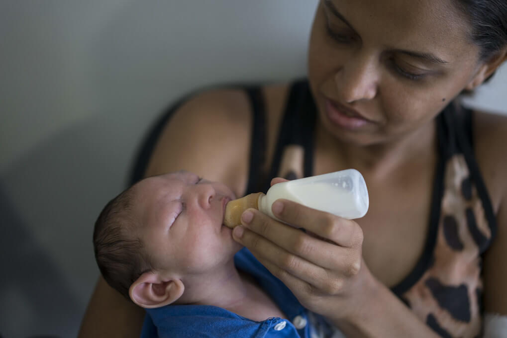 Daniele Ferreira dos Santos feeds her son Juan Pedro, who suffers from microcephaly, as they wait to be examined at the Altino Ventura Foundation, a treatment center that provides free health care, in Recife, Pernambuco state, Brazil, Thursday, Feb. 4, 2016. Brazil is in the midst of a Zika outbreak and authorities say they have also detected a spike in cases of microcephaly in newborn children, but the link between Zika and microcephaly is as yet unproven. (AP Photo/Felipe Dana) XFD101   (Felipe Dana / The Associated Press)